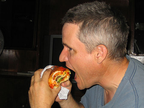 Tom eating a hamburger